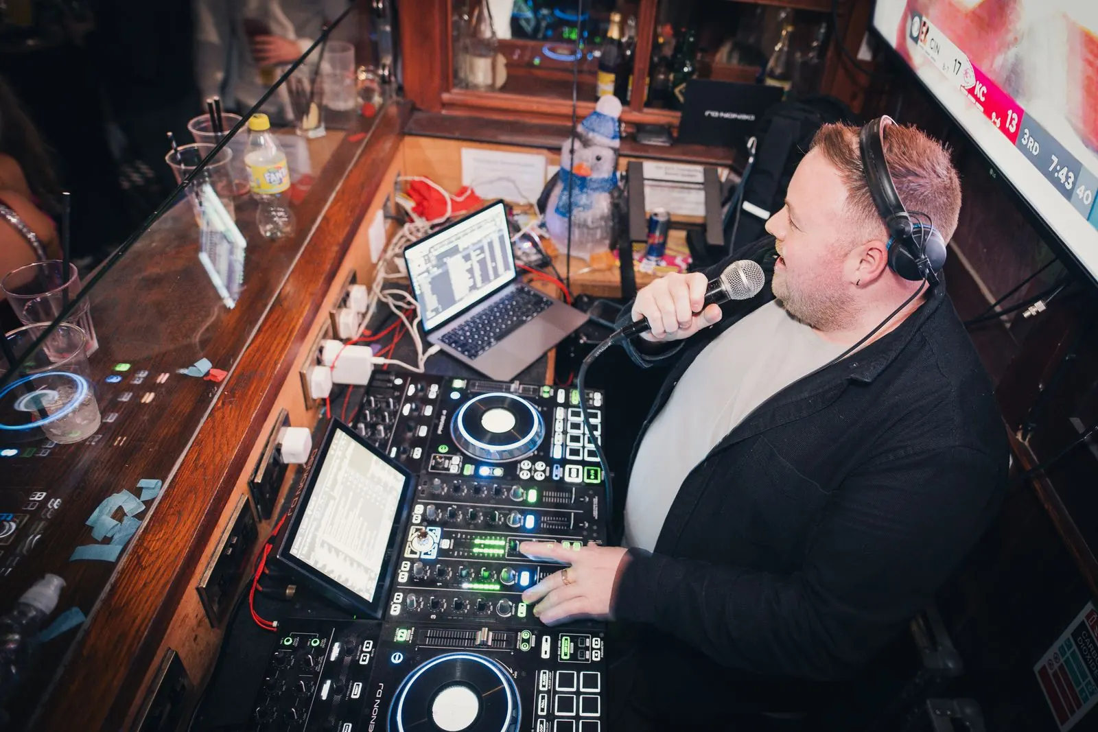 A DJ playing to a full bar at Quinns